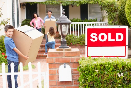 Moving team handling furniture near Shepherds Bush streets
