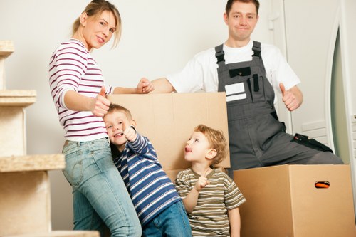 Packed moving boxes and furniture prepared for transport in Shepherds Bush